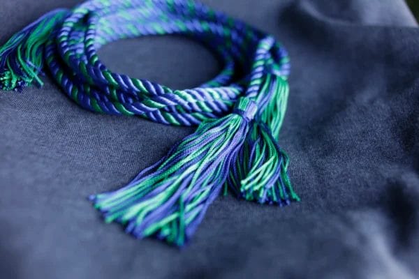 Close up of blue and green graduation cords